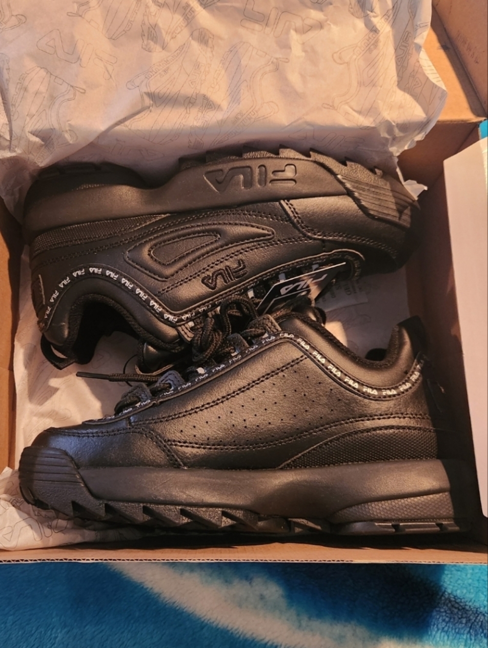Woman's All-Black Fila Sneakers
